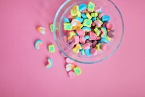 Lucky Charms cereal marshmallows on pink table | LGBTQ Couples Counseling & Therapy | Eleni Economides | Better Relationship Counseling | Rochester, NY 14625